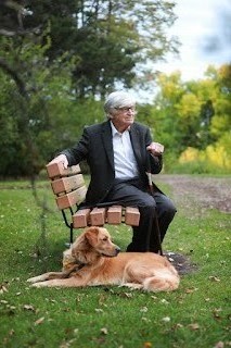 Tony Doerksen sitting outdoors with golden retriever